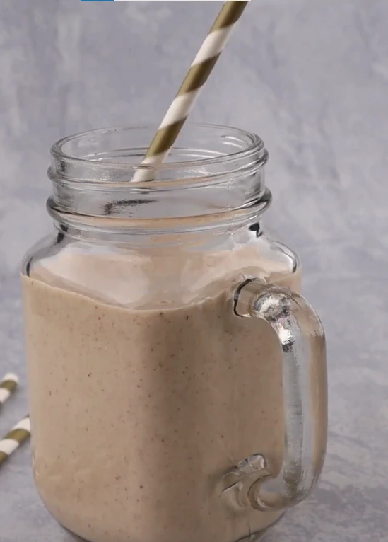 Creamy banana oat smoothie made with oats, cashews, milk, and cinnamon