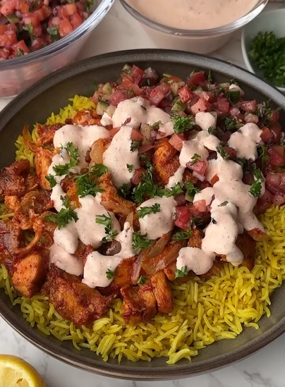 Chicken harissa salad bowl with spinach, roasted bell peppers, quinoa, lentils, and cottage cheese harissa sauce