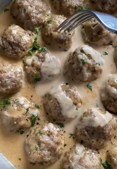Creamy meatballs with peas in meal prep containers