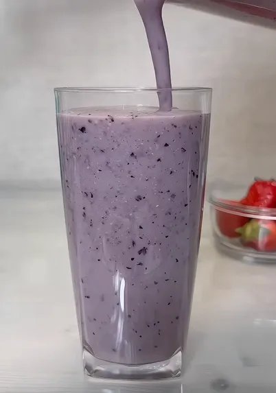 High-protein fruit smoothie with banana, avocado, frozen fruit, and greens