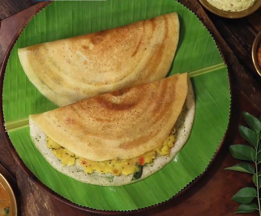 Crispy instant millet dosa topped with onion and carrot for a savory breakfast