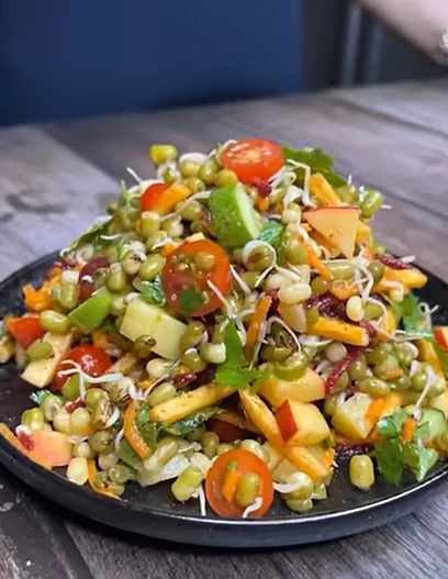 Moong sprout chaat with onion, tomato, lemon, and spices in a fresh breakfast bowl