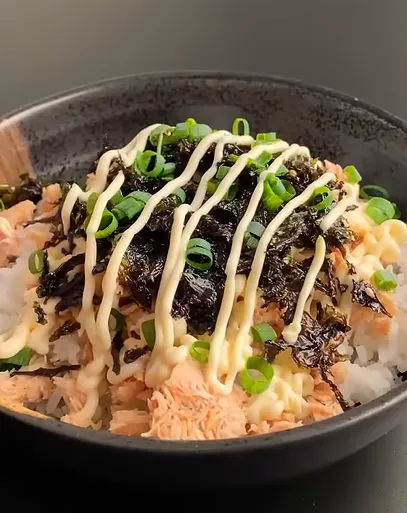 Savory tuna and rice breakfast bowl with green onions and cucumber