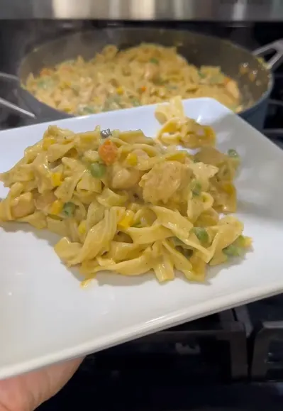 Creamy chicken pot pasta in a skillet with parsley