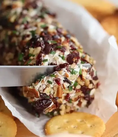 Cream cheese cracker bites topped with dried cranberries and rosemary
