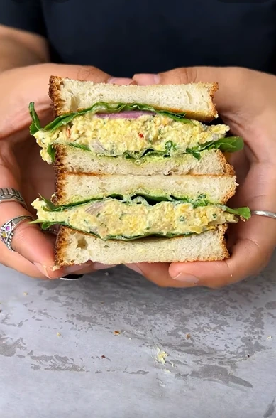 Easy vegan chickpea salad sandwich with lettuce and tomato on soft bread
