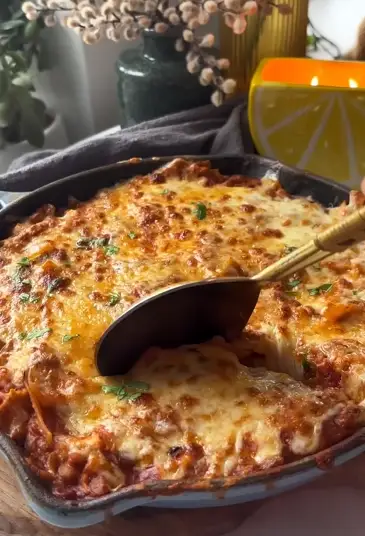 Skillet lasagna with melted cheese and herbs
