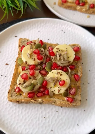 Nut butter toast topped with hemp seeds and honey drizzle
