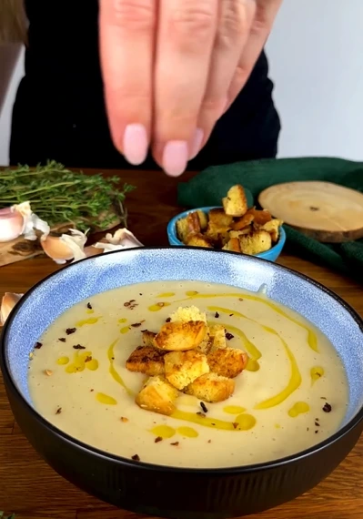 Creamy spiced parsnip soup topped with crispy roasted parsnip strips