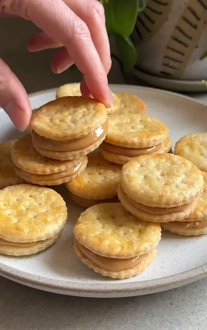 Homemade peanut butter sandwich crackers on a wooden board