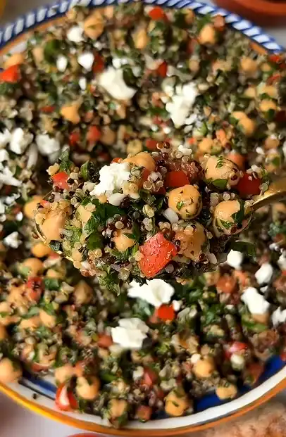 Quinoa tabouli with parsley, mint, tomatoes, cucumber, lemon juice, and olive oil.