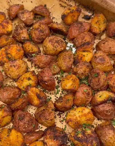 Raw diced potatoes tossed with taco spices and oil before roasting