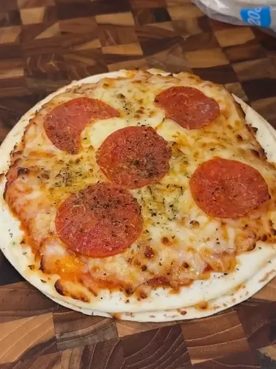 Crispy skillet tortilla pizza with melted cheese