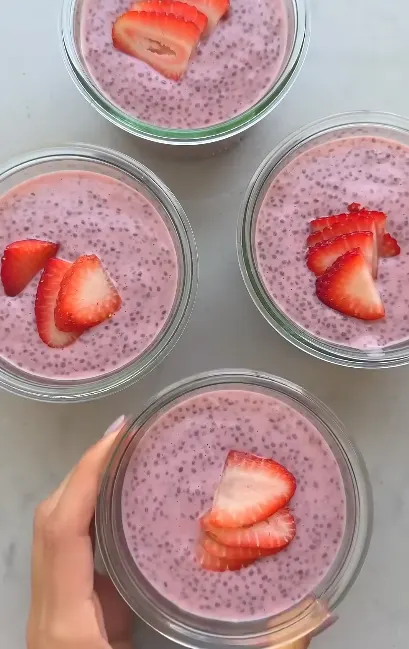 Greek yogurt bowl with sliced strawberries, chia seeds, and honey
