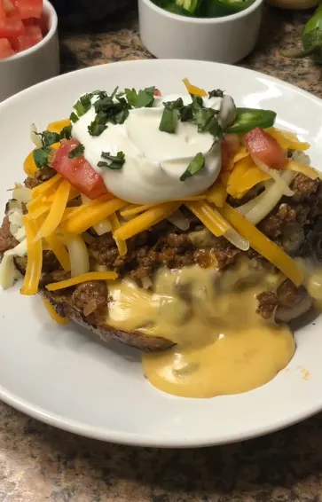 Taco stuffed potatoes topped with cheesy beef and fresh toppings