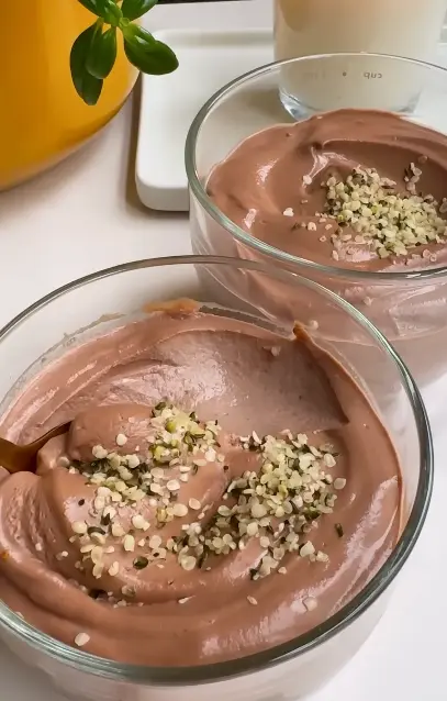 Creamy vegan peanut butter mousse made with silken tofu and topped with chocolate chips and crushed peanuts