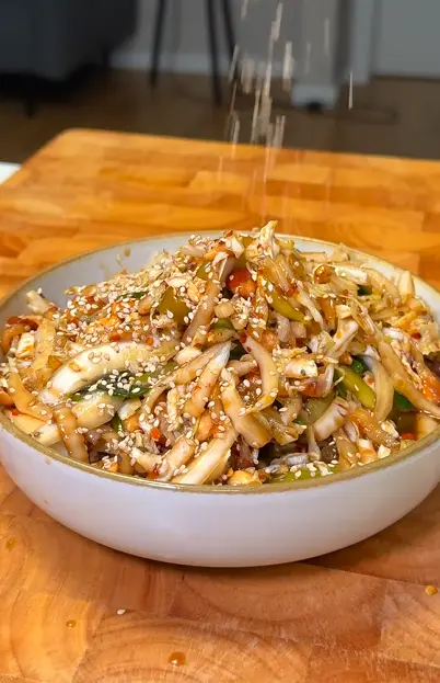 Crunchy vegan cabbage salad with edamame, carrots, cashews, cilantro, and creamy ginger dressing