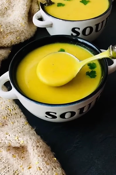 Hearty veggie mulligatawny soup with butternut squash, rice, peas, spinach, and curry spices