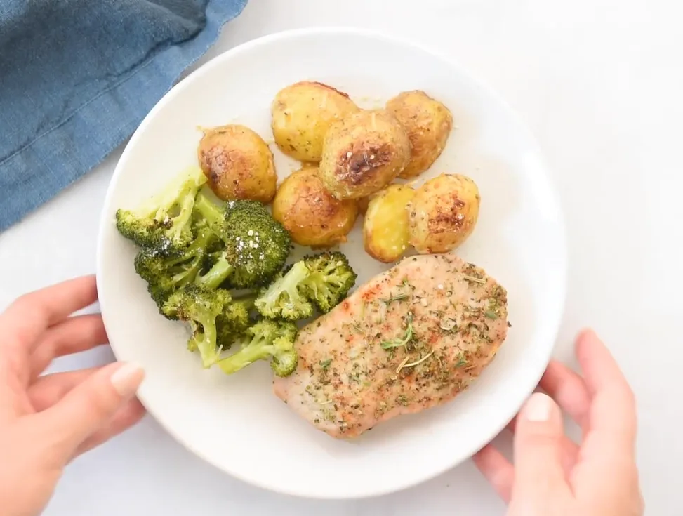 Pork chops with mushroom sauce, baked potato, and broccoli