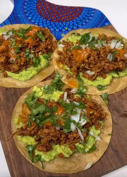 Vegan breakfast tacos with black beans, Just Egg scramble, spinach, avocado, and salsa